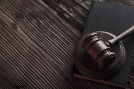 Auction and business concept.  Gavel and commercial code on the wooden background.
