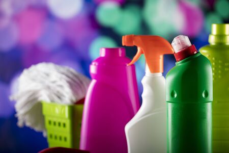Cleaning products on colorful bokeh background and glass table.の写真素材