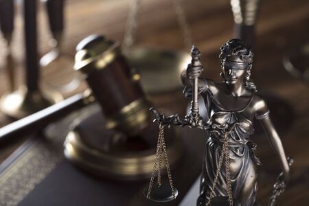 Themis and judge antique gavel. Law symbols. Legal office. Wooden table and background.の写真素材