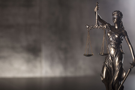 Courtroom concept. Themis â symbol of blind justice. Gray stone background.の写真素材