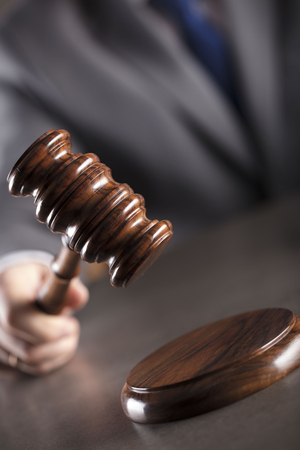 Judge in the courtroom. Gavel on the table. Law and justice theme.の写真素材