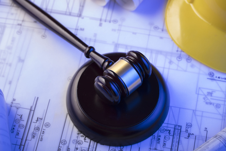 Labor and construction law. Gavel, helmet and blueprints.の写真素材