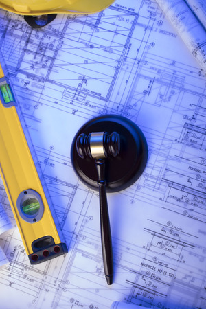 Labor and construction law. Gavel, helmet and blueprints.の写真素材