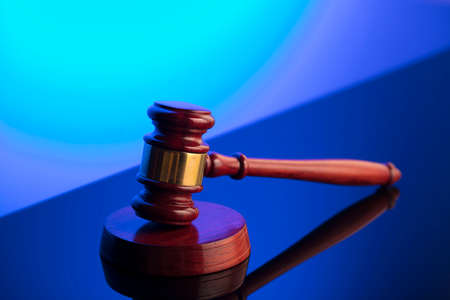 Law symbol. Gavel on blue background. Place for or text.の写真素材