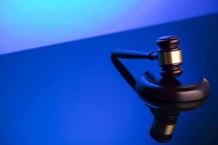 Law symbol. Gavel on blue background. Place for or text.の写真素材