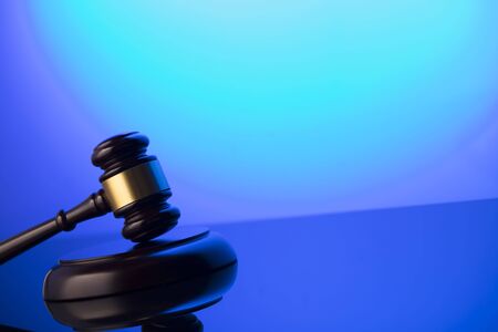 Law symbol. Gavel on blue background. Place for or text.の写真素材