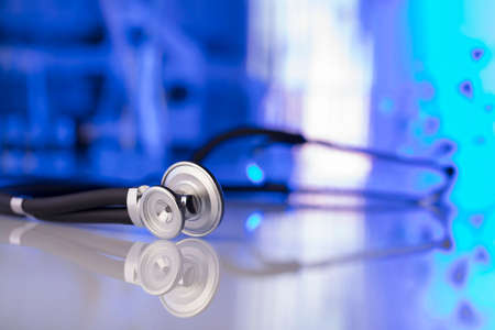 Healthcare, medical concept. Stethoscope, microscope,  lab glassware.  Blue background.の写真素材