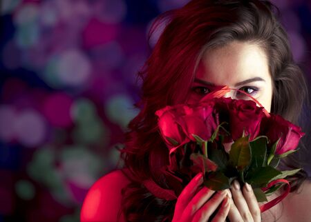 Valentines day oncept. Pretty girl on colorful bokeh background.の写真素材