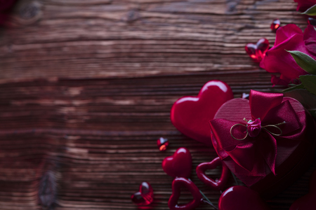 Valentines day background. Hearts, roses, gifts and romantic decorations  on rustic wooden table. Place for typography.の写真素材