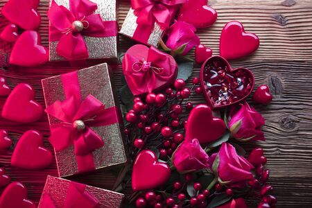 Valentines day background. Hearts, roses, gifts and romantic decorations  on rustic wooden table. Place for typography.の写真素材