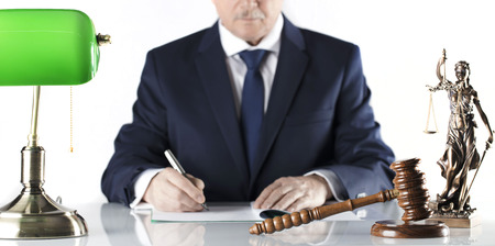 Legal counsellor. Mallet and Themis statue on white table and background.の写真素材