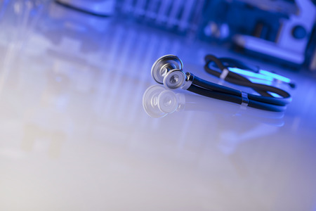 Healthcare, medical concept. Stethoscope, microscope,  lab glassware.  Blue background.の写真素材