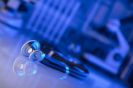 Healthcare, medical concept. Stethoscope, microscope,  lab glassware.  Blue background.