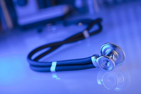Healthcare, medical concept. Stethoscope, microscope,  lab glassware.  Blue background.の写真素材