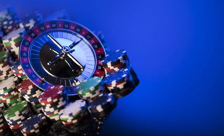 Casino. High contrast image of casino roulette. Poker chips. Blue background.の写真素材
