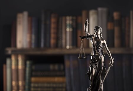 Law symbols on brown background. Statue of justice - Themis.の写真素材