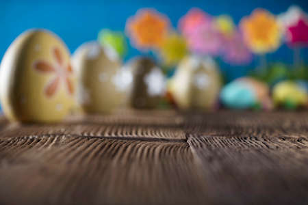 Easter background. Easter eggs, tulips, rustic wooden table. Place for text.の写真素材