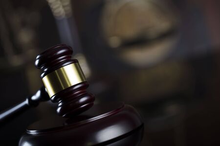 Law theme. Judge antique gavel. Bookshelf background.