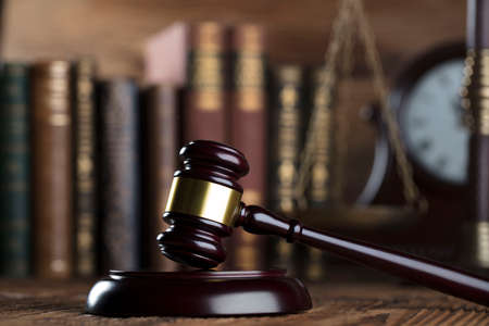 Law firm concept. Gavel, clock, books, balance. Brown background.の写真素材