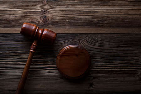Law concept. Judges gavel on rustic wooden table. Top view.の写真素材