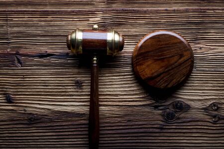 Law concept. Judges gavel on rustic wooden table. Top view.