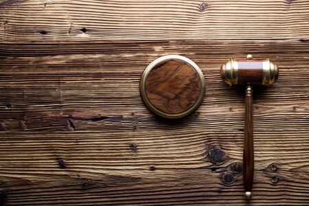 Law concept. Judges gavel on rustic wooden table. Top view.の写真素材