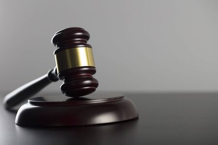 Law and justice concept. Gavel - law symbol on gray background.