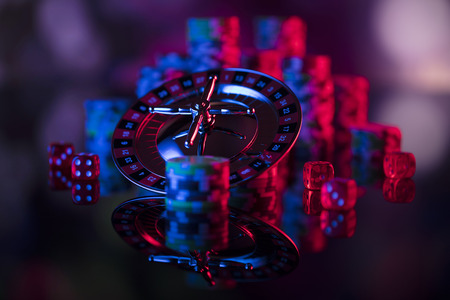 Gamling theme. Close up of roulette and stack of chips. Blue light.  Bokeh background.の写真素材