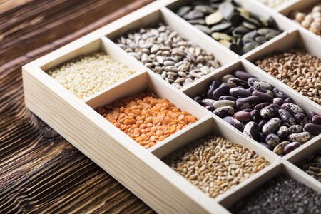 Healthy food and diet theme. Lentils, peas, beans, protein food in bowls, on a wooden table.の写真素材