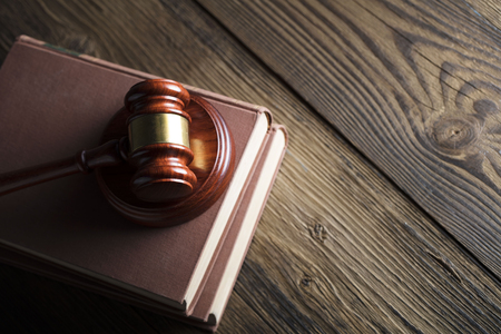 Labour law concept. Gavel, labour code on rustic wooden table. Top view. Place for text.の写真素材