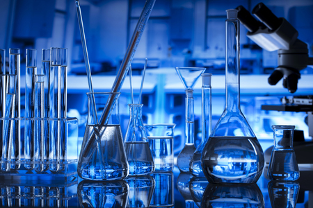 Science concept background. Chemical experiment. Beakers and microscope in laboratory.の写真素材