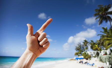 Summer on Barbados Island. Exotic vacations. Palm trees. Turquoise water. Sunny blue sky. Beautiful white-sand beach.の写真素材