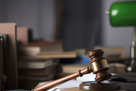 Antique gavel on the law symbols background.の写真素材