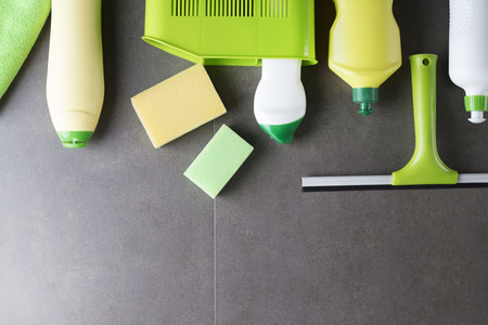 House and office cleaning up theme.  Set of colorful cleaning products on gray background. Top view.の写真素材