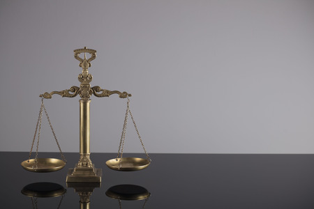 Justice concept. Antique scale on the gray background.の写真素材