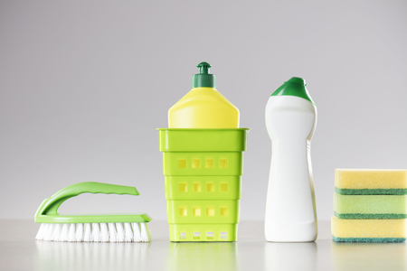 House and office cleaning up theme.  Set of colorful cleaning products on gray background.の写真素材