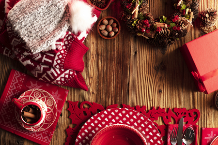 Christmas decorations, presents and tableware on wooden rustic table.の写真素材