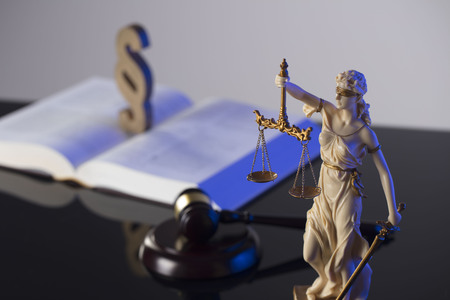 Law concept. Gavel of  the judge, scale, statue of the justice and legal book. Gray background.
