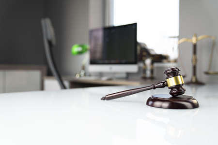 Lawyers office. Gavel, scale and computer on the white table.の写真素材