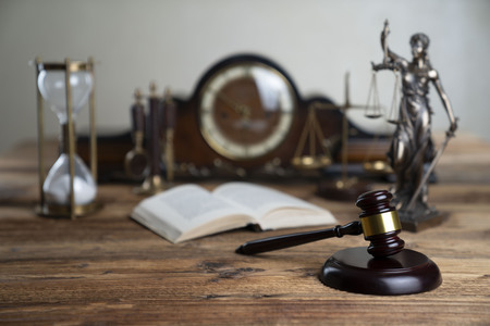 Law concept. Judges gavel on rustic wooden table.の写真素材