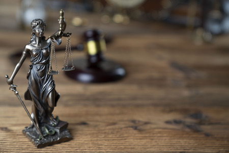 Law symbols â Themis and judge's gavel on the rustic wooden table.の写真素材