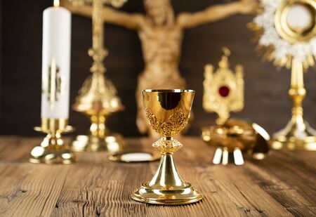 Catholic concept background. The Cross, monstrance and golden chalice on the altar.
