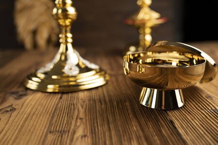 Catholic concept background. The Cross, monstrance and golden chalice on the altar.