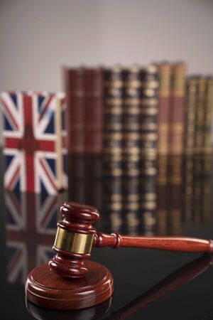 Law theme. Judge's gavel and legal books on gray background.の写真素材