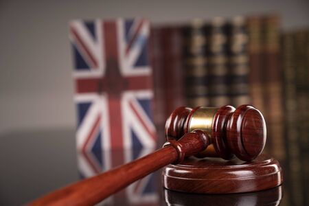 Law theme. Judge's gavel and legal books on gray background.の写真素材