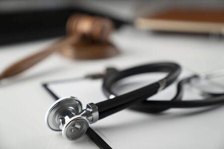 Medical law concept.  Gavel and stethoscope on the wihte table.の写真素材