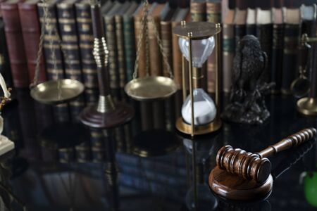 Judge, justice concept background. Gavel, statue of justice and scale in the old university library.
