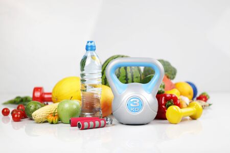 Fitness concept â€“ healthy nutrition and equipment for fitness exercises on the white...
