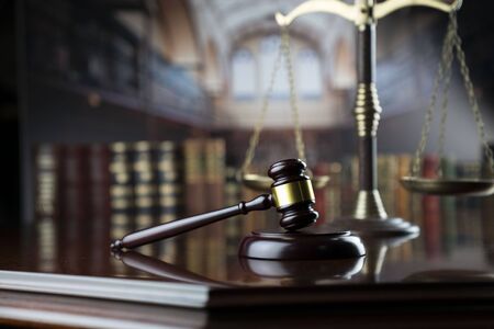 Law theme. Judge gavel and scale of justice in the law faculty library.の写真素材