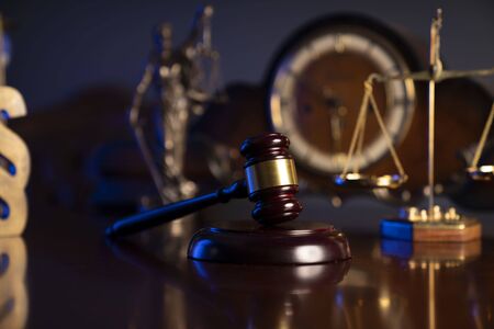 Law concept. Judgeâs gavel, paragrahp sign, old clock and scale on dark background.の写真素材